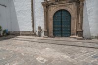 a street scene with a very ornate door and a statue in front of it -