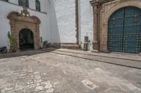 a street scene with a very ornate door and a statue in front of it -