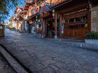 an old street lined with wooden buildings in the town of dali, yunnan, china