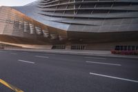 a cyclist is leaning against a street while looking down a highway at the building in the foreground