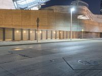 a empty, empty parking lot in front of a building in downtown san francisco at night