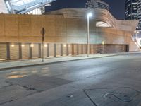 a empty, empty parking lot in front of a building in downtown san francisco at night