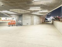 an empty parking lot at night time with orange chairs set out for people to eat