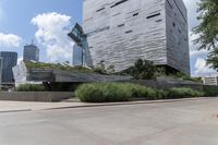 a grey and silver building that looks great with many trees on top of the building