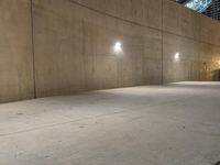 a skateboarder is doing tricks in the parking garage on a cement sidewalk at night