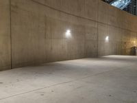 a skateboarder is doing tricks in the parking garage on a cement sidewalk at night