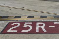 an airport runway with red and white markings of 23r - 3l numbers on the pavement