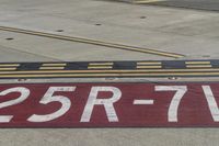 an airport runway with red and white markings of 23r - 3l numbers on the pavement