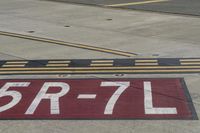 an airport runway with red and white markings of 23r - 3l numbers on the pavement