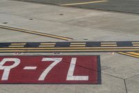 an airport runway with red and white markings of 23r - 3l numbers on the pavement