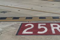 an airport runway with red and white markings of 23r - 3l numbers on the pavement