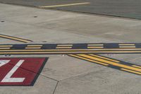 an airport runway with red and white markings of 23r - 3l numbers on the pavement