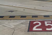 an airport runway with red and white markings of 23r - 3l numbers on the pavement