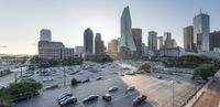 cityscape of the downtown and downtown parking lot at sunrise, with traffic on each side