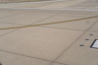 this is an image of the plane at the airport with the yellow line on the ground