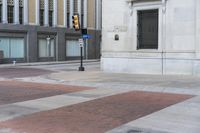 a man walking across a sidewalk in a red shirt and brown jacket towards a building