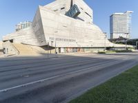 there is a large building on the corner of the highway that leads to a small city