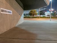 a parking garage and a sign for general public transportation is pictured in the dark side of a road