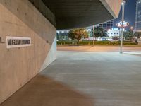 a parking garage and a sign for general public transportation is pictured in the dark side of a road