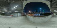 a circular panoramic photo of an urban skyline at night, taken from the ground