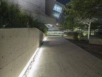 this is the image of a parking lot with a building in the background at night