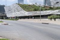 an empty city street with buildings and vegetation on top of it as if there were in the middle of an accident