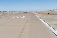 an airplane landing strip is on the runway on a sunny day, at the airport