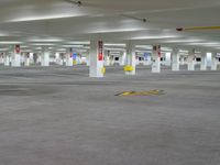 a empty parking lot with yellow arrows for parking and markings on the ground, the sign indicates where to park