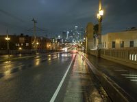 city lights shine brightly above a dark street in this shot of an old style road