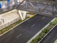 a view of a road and an overpass with traffic passing through it by buildings