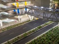 a view of a road and an overpass with traffic passing through it by buildings