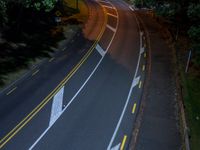 a bird's - eye view of a roadway at night with no cars going along