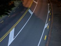 a bird's - eye view of a roadway at night with no cars going along