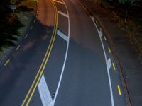 a bird's - eye view of a roadway at night with no cars going along