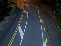 a bird's - eye view of a roadway at night with no cars going along