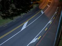 a bird's - eye view of a roadway at night with no cars going along