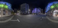 a view of the street in a city at night taken with fisheye lense