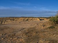 the kite is flying above the open desert area of the countryside of southern africa,