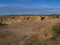 the kite is flying above the open desert area of the countryside of southern africa,