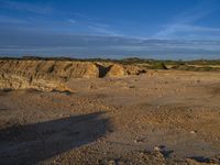 the kite is flying above the open desert area of the countryside of southern africa,