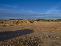 the kite is flying above the open desert area of the countryside of southern africa,