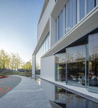 a courtyard is shown with a fountain, a concrete walkway and outdoor space in the foreground