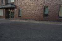 a building with two windows on the side of it and an old car parked by the side