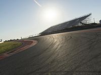 Dawn on an Asphalt Road: A Field and Clear Sky