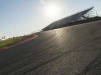 Dawn on an Asphalt Road: A Field and Clear Sky