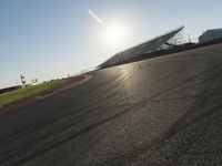 Dawn on an Asphalt Road: A Field and Clear Sky