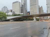 city street and road with highway with bus lanes in the evening time, and skyscrapers in the background