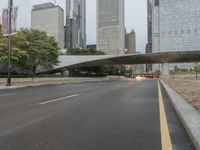 city street and road with highway with bus lanes in the evening time, and skyscrapers in the background