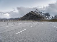 this is an image of an empty highway with mountains and a sky background at the top