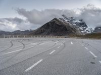 this is an image of an empty highway with mountains and a sky background at the top